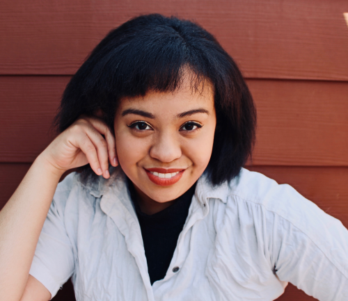 Queer Author Emery Lee with brown hair, brown eyes, and medium skin tone.