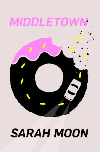 Grey background and center-framed donut with a car driving inside of the donut.