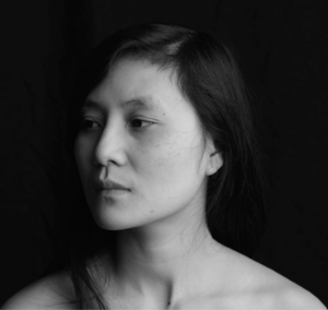 Grayscale photo of Vi Khi Nao against a black backdrop.